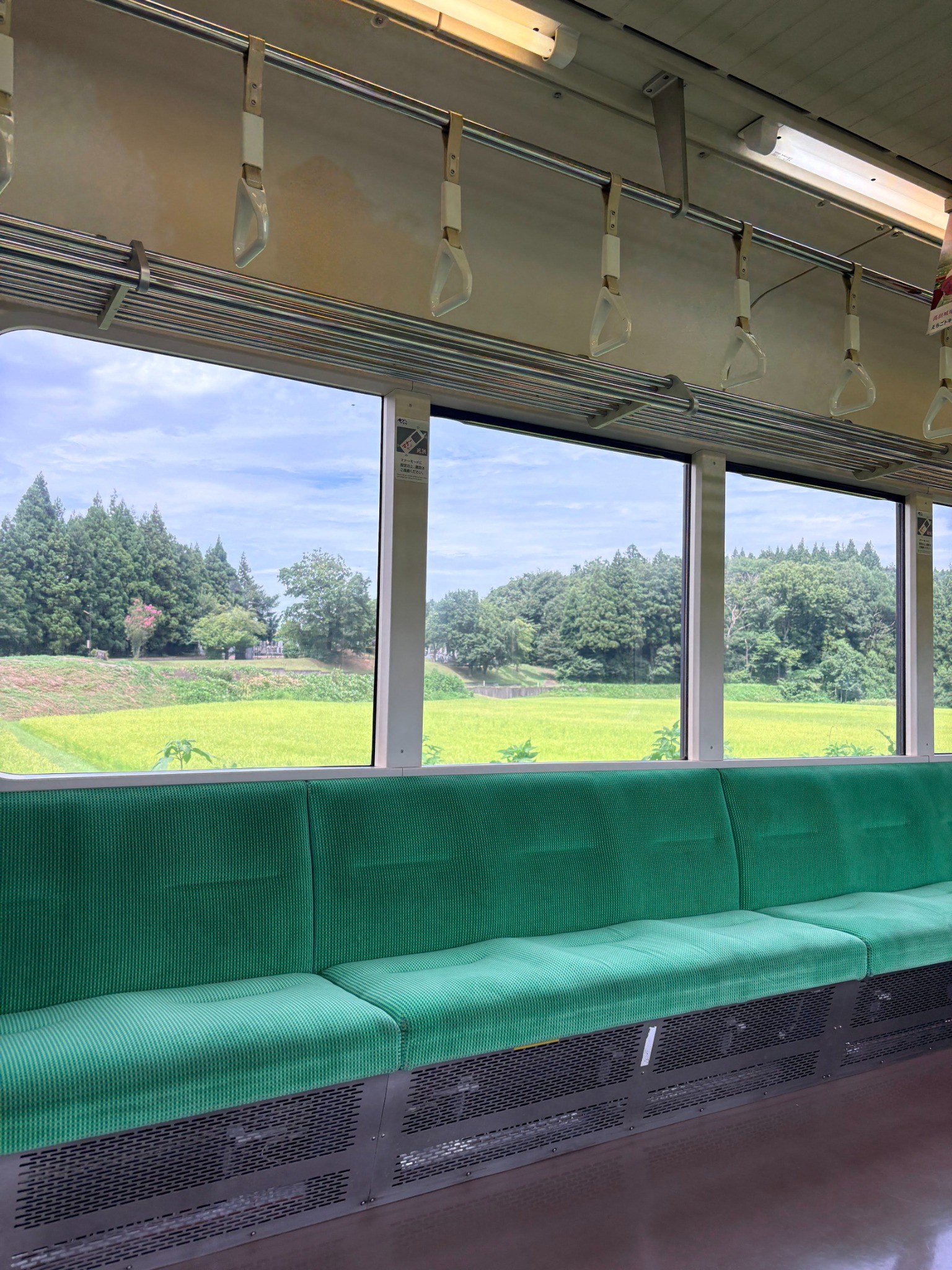 Countryside seen through the windows of a local train