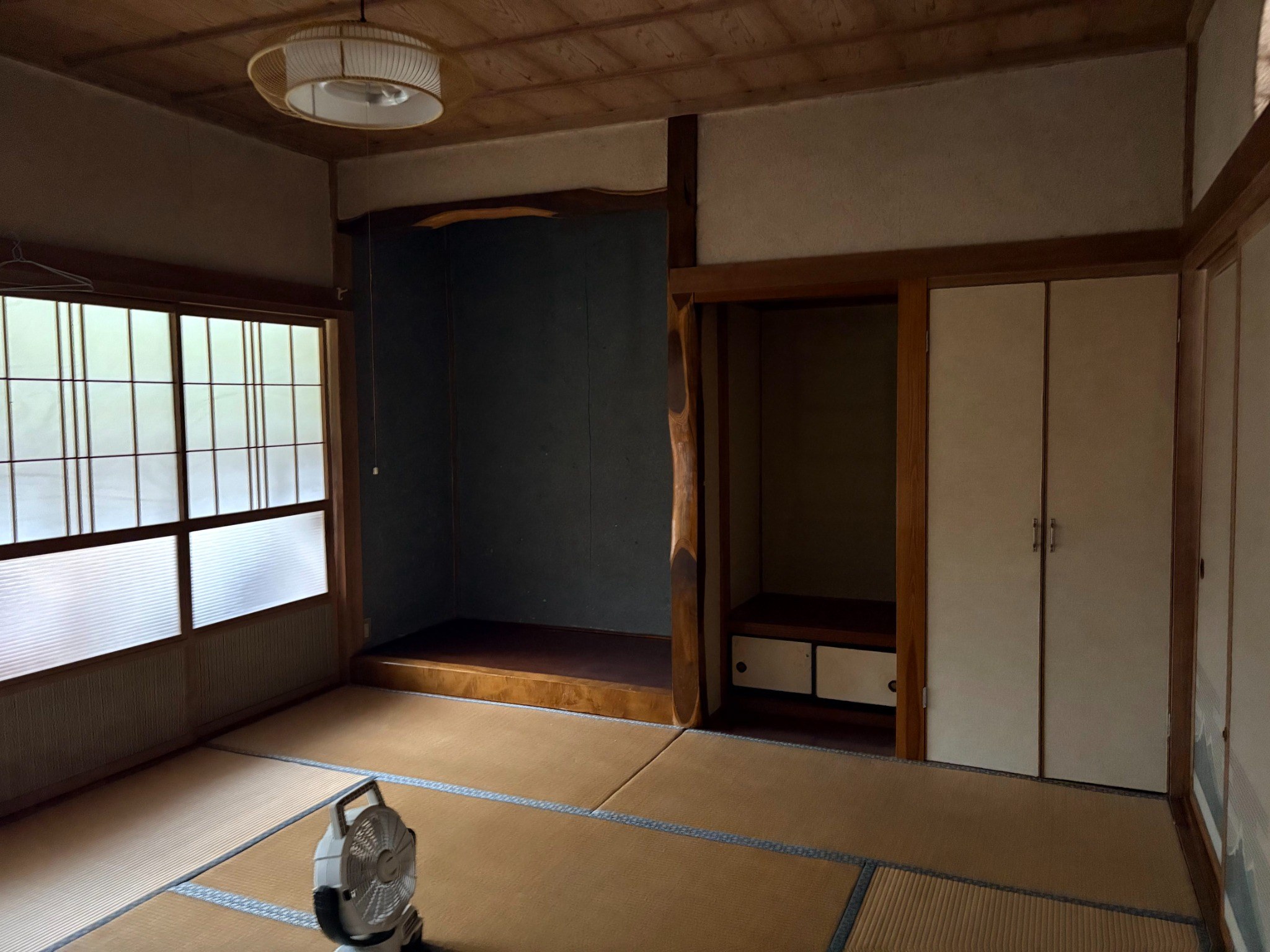 Tatami room with timber beams and traditional sliding screens